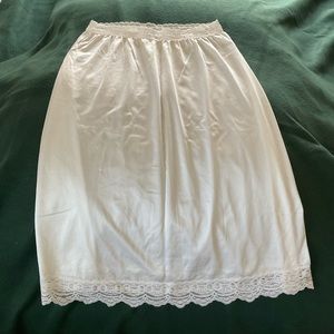 NWOT. Silky white half slip